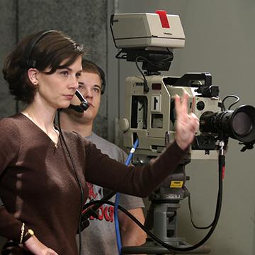 Students record a meeting with a videocamera.